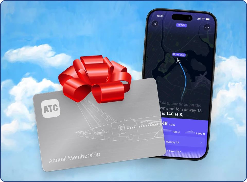 ATC app on an iPhone beside a silver annual membership card and red gift bow, against a blue sky