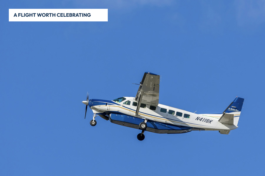 Blue and white Cessna Grand Caravan in flight